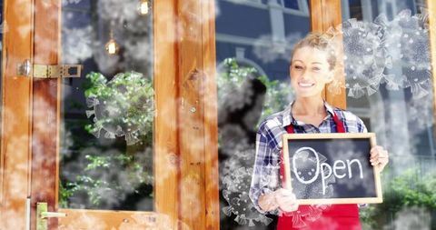 Female Entrepreneur Holding 'Open' Sign at Storefront During Pandemic