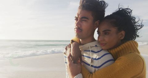 Romantic Biracial Couple Embracing on Serene Beach