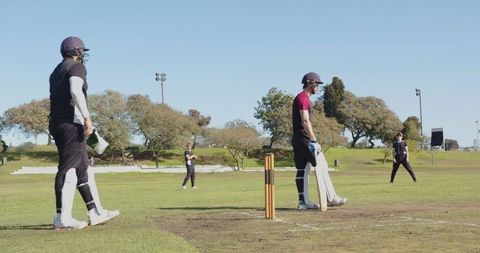 Cricket players preparing for match on sunny day