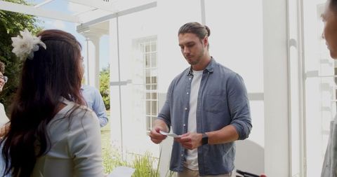 Guests Engaging in Lively Wedding Conversation Outdoors