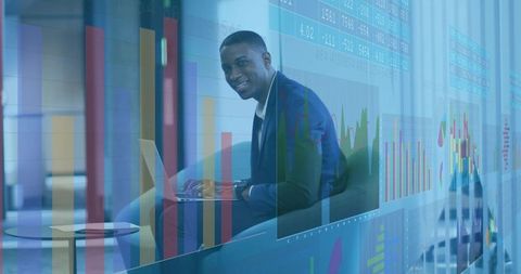 Businessman working on laptop with financial charts and data visualization overlay in modern lounge