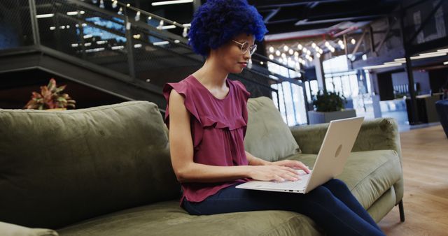 Young Woman with Blue Hair Working on Laptop in Modern Office Lounge - Download Free Stock Images Pikwizard.com