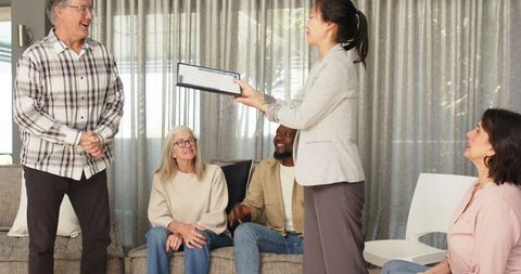 Therapist awarding certificate during group therapy session