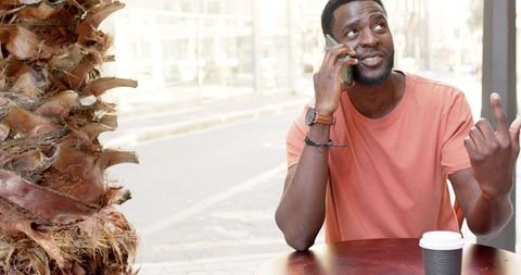 Casual Urban Outdoor Phone Conversation at Cafe