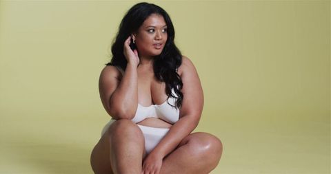 Confident Plus Size Woman Posing in Minimalistic Studio