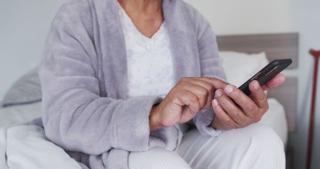 Senior Woman in Pajamas Using Smartphone on Bed - Download Free Stock Images Pikwizard.com