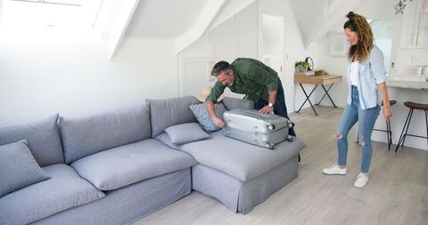 Couple Packing Suitcase Together at Home for Vacation