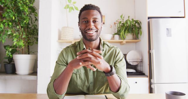 Confident African American Man Smiling at Home Desk with Plants - Download Free Stock Images Pikwizard.com