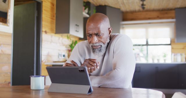 Older Man Using Digital Tablet in Modern Kitchen - Download Free Stock Images Pikwizard.com