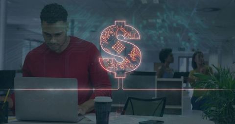Hispanic man typing at office desk with neon dollar sign