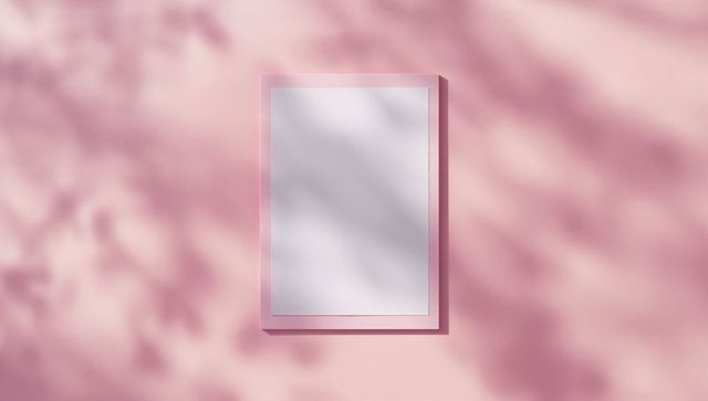 Blank poster with pink frame on pastel wall with shadow play
