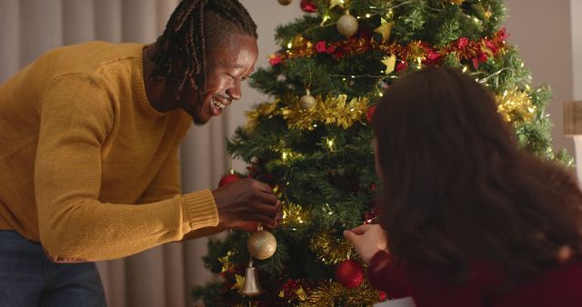 Young Individuals Decorating Christmas Tree with Ornaments - Download Free Stock Images Pikwizard.com