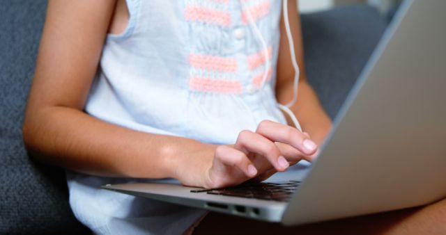 Child Typing on Laptop with Earphones and Summer Dress - Download Free Stock Images Pikwizard.com