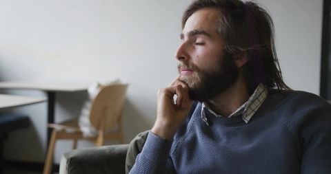 Contemplative Man Relaxing in Minimalist Living Space