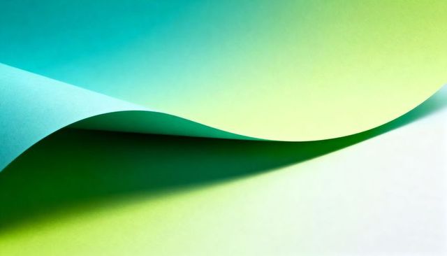 Curved teal lime paper wave showing smooth gradient light, cast shadow and negative space