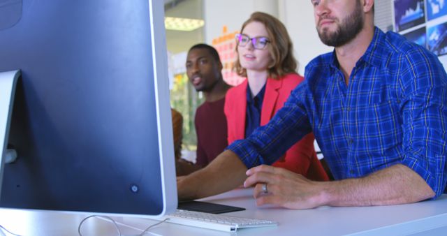 Young biracial business team discussing over computer in modern office - Download Free Stock Photos Pikwizard.com