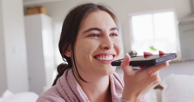 Smiling Woman Using Voice Command on Smartphone at Home - Download Free Stock Images Pikwizard.com