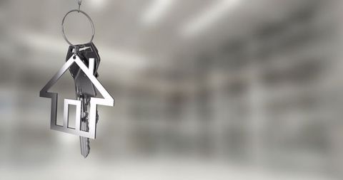 House-Shaped Keychain Symbolizing Homeownership and Real Estate Concept