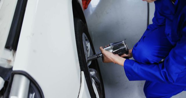 Female Mechanic Fitting Wheel at Auto Repair Shop - Download Free Stock Images Pikwizard.com