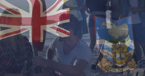 Friends Relaxing on Beach with Union Flag Pilgrimage