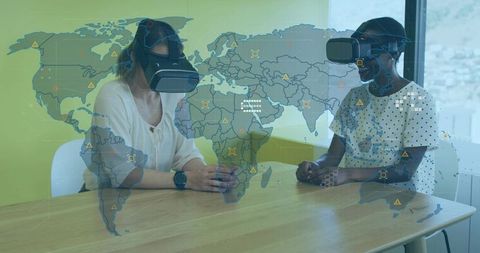 Two women wearing vr headsets collaborating with world-map hud for remote training and simulation