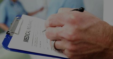 Patient Completes Medical History Form in Clinical Environment