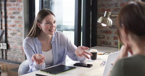 Young Professional in Discussion with Senior Colleague at Office Desk - Download Free Stock Images Pikwizard.com