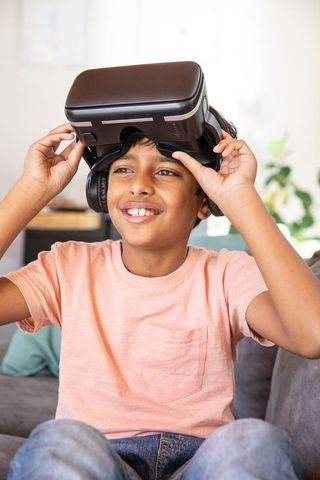 Indian Boy Engaging with Virtual Reality and Headphones at Home
