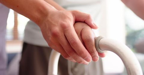 Coupled Hands Displaying Support During Physiotherapy Session
