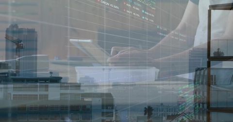Man tapping tablet with financial chart overlays and city skyline double exposure