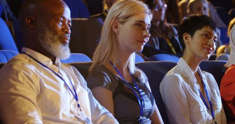 Diverse business professionals attentively listening at conference