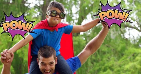 Boy as superhero on dad's shoulders with comic effects