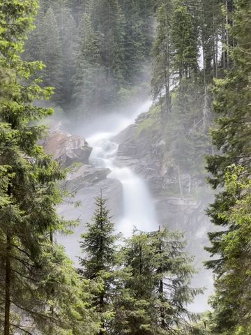 Majestic Mountain Waterfall Surrounded by Lush Forest