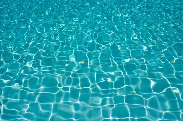 Sunlight creating patterns in clear blue swimming pool water - Download Free Stock Photos Pikwizard.com