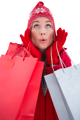 Excited woman in winter attire holding shopping bags transparent