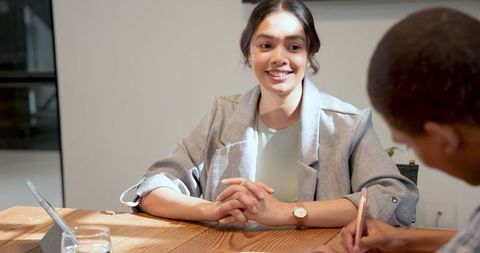 Businesswoman Reviewing Documents during Office Meeting