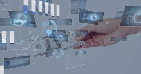 Hand holding us dollar bill amid holographic financial dashboards and global data