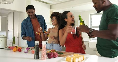 Diverse Friends Socializing and Cooking in Modern Kitchen