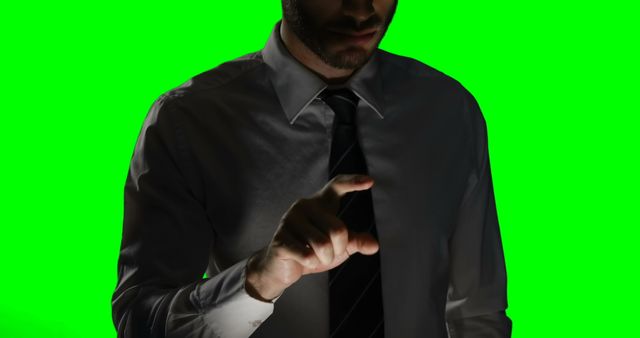 Man touching digital screen against green screen background