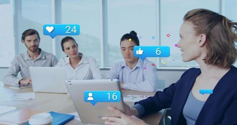 Presenting woman holding tablet with social engagement overlays in bright office meeting