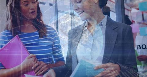 Businesswomen Discussing Amidst Digital Data Overlay