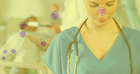 Compassionate nurse in scrubs with heart symbols in hospital
