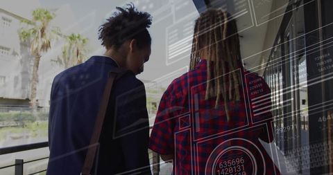 Colleagues analyzing digital data in outdoor business environment