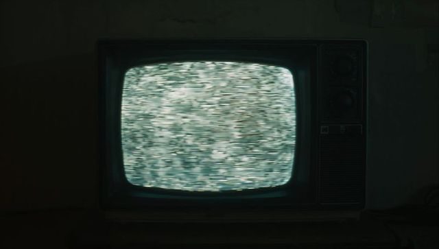 Retro Television with Static Screen in Dimly Lit Basement