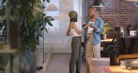 Two Women Collaborating in Modern Office Environment