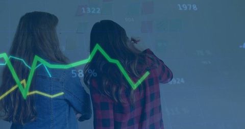 Two Women Analyzing Data Trends on Interactive Display