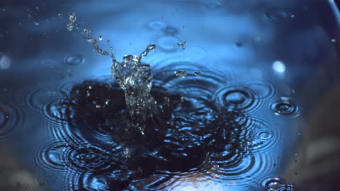 Onion Splash Creates Dynamic Water Ripples in Blue Lighting