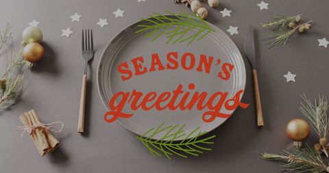 Festive table setting with season's greetings overlay