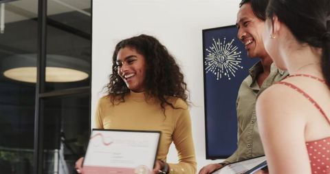 Diverse Team Members Celebrating Achievement in Contemporary Office