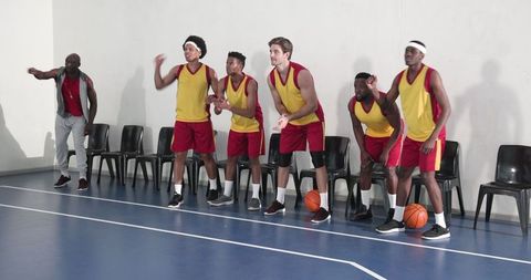Multicultural Basketball Team and Coach Focused and Ready for Play